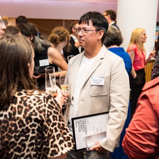Person holding their award talking